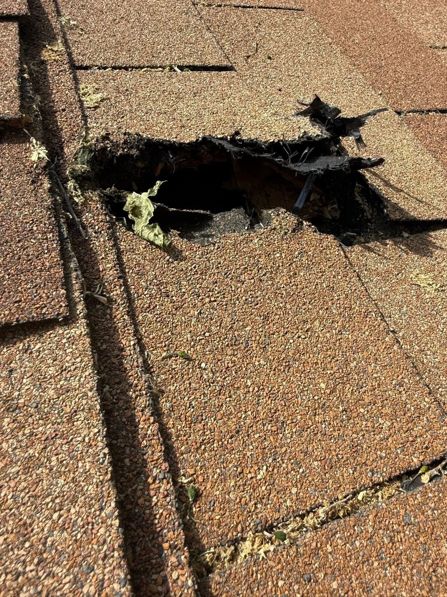 A close up of a roof with a hole in it.