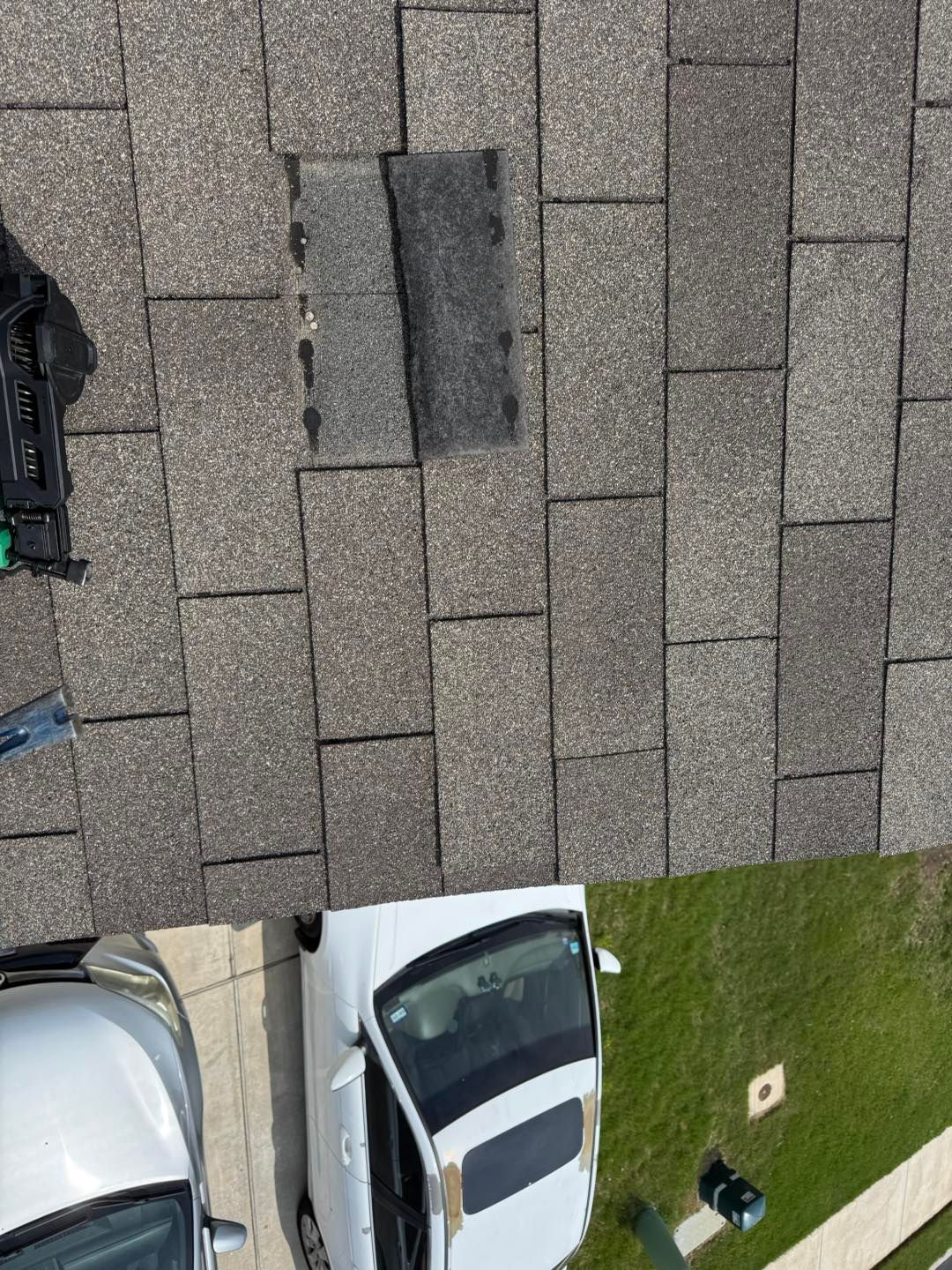 An aerial view of a roof with a car parked on it.