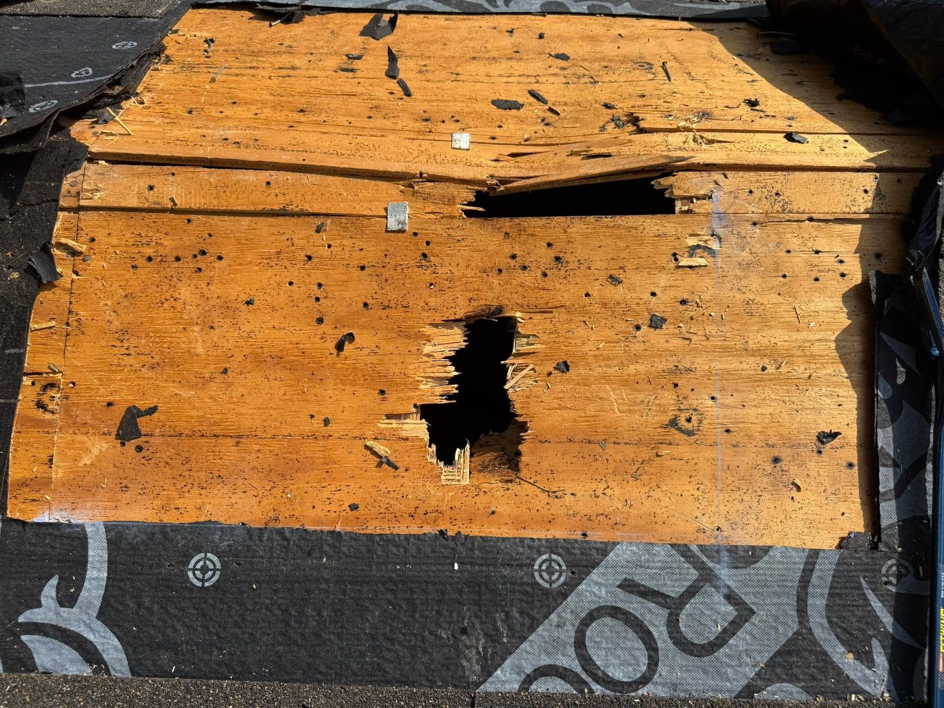 A piece of wood with a hole in it is sitting on top of a roof.