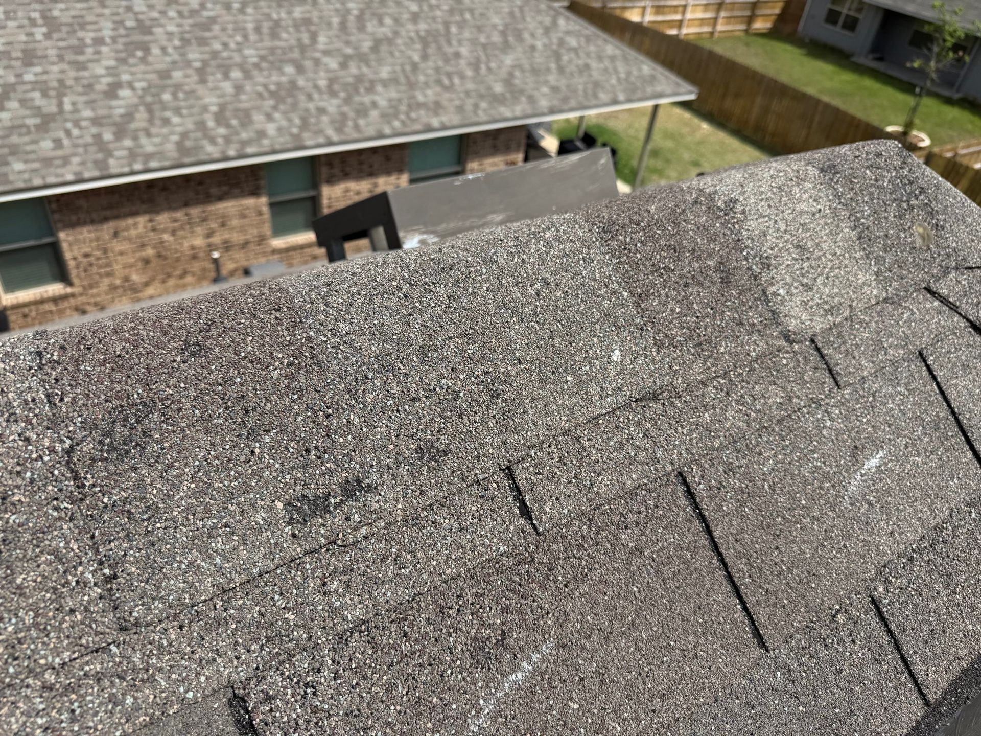 An aerial view of a roof of a house with shingles on it.