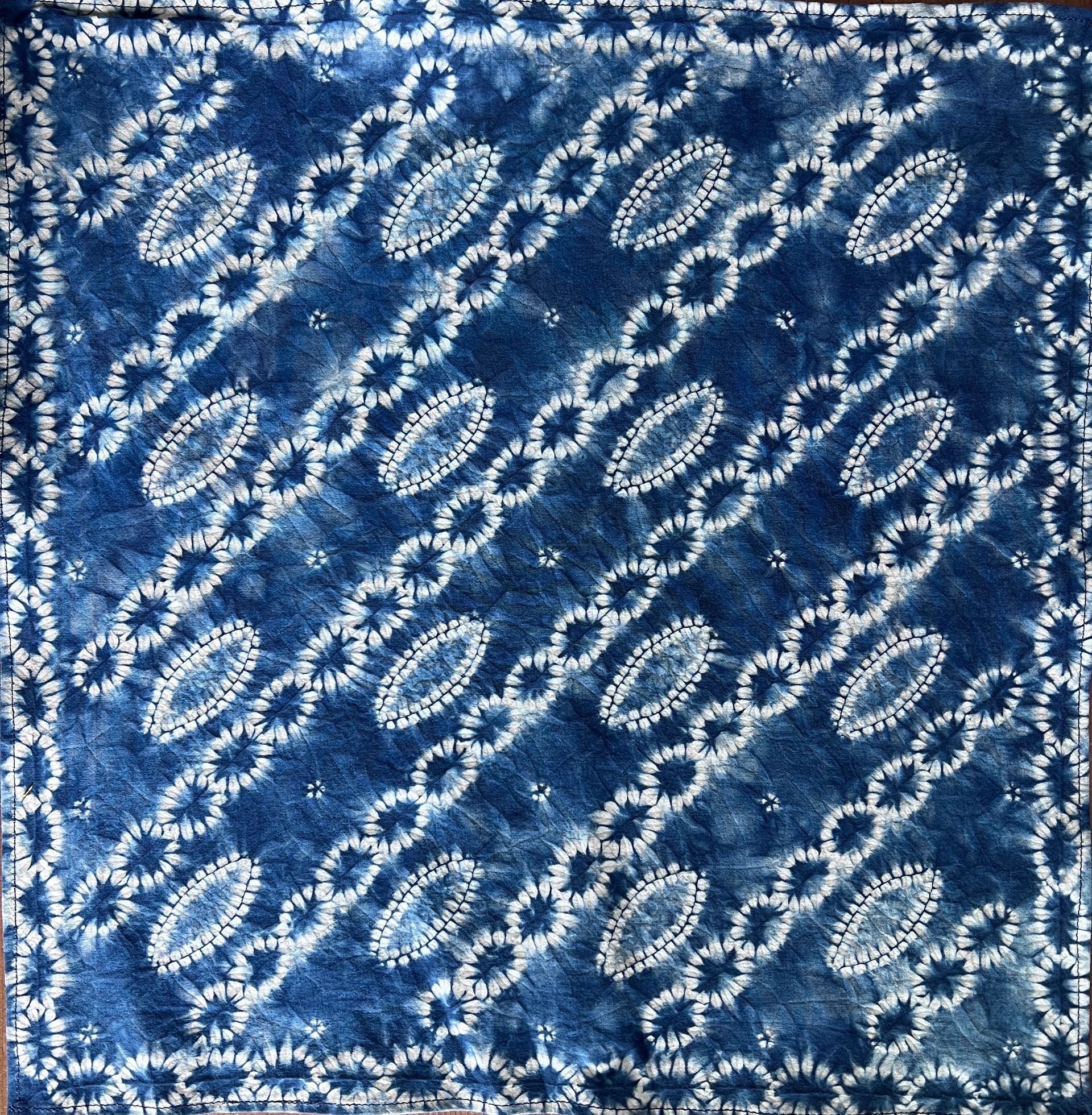Abstract blue pattern with white oval and diagonal floral motifs