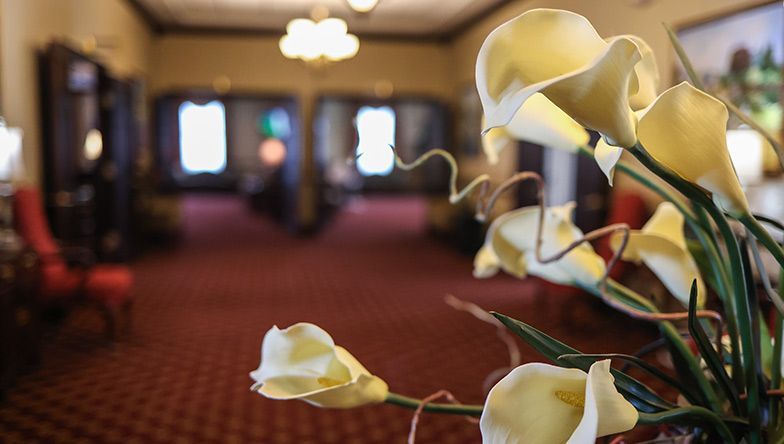 A bunch of flowers are sitting on a table in a room.