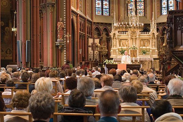 A large group of people are sitting in a church.