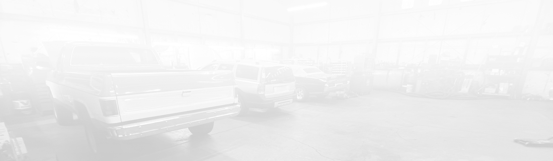 A high-angle view of a workshop floor with a pickup truck parked in the foreground. | Maynard's Auto Repair Service
