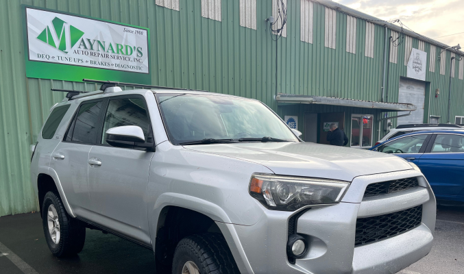 Silver Toyota 4Runner parked in front of the Maynard's Office Supplies green building. | Maynard's Auto Repair Service