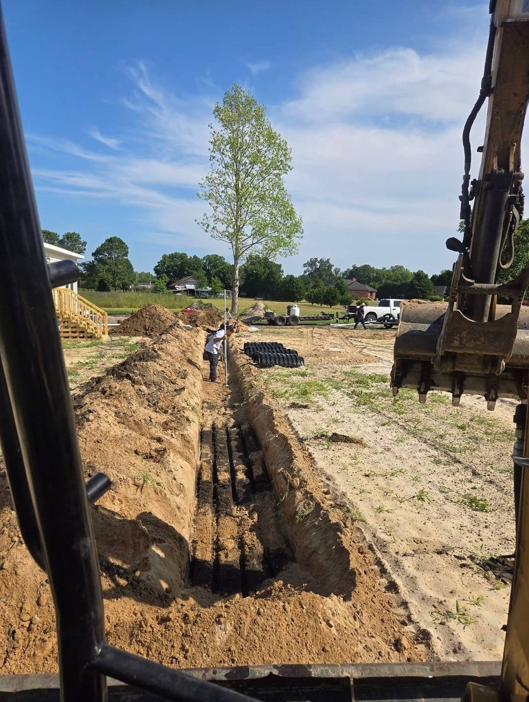 A bulldozer is digging a hole in the dirt in a field.