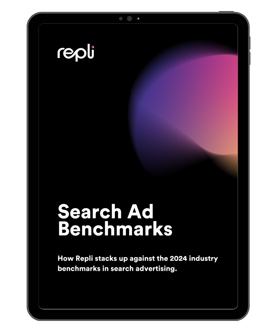 A tablet with a search ad benchmarks report on it.