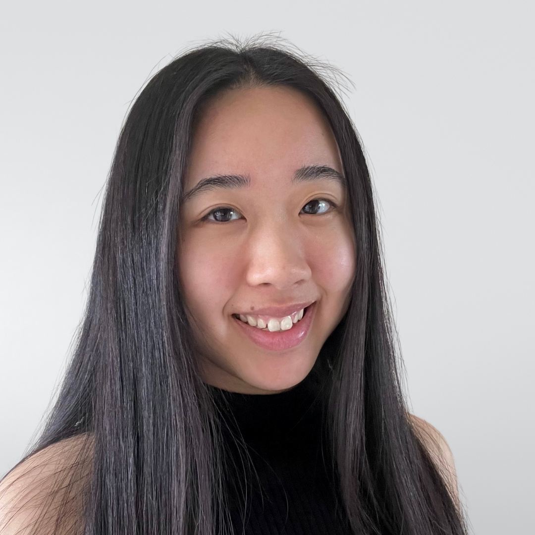 A young woman with long black hair is smiling for the camera.