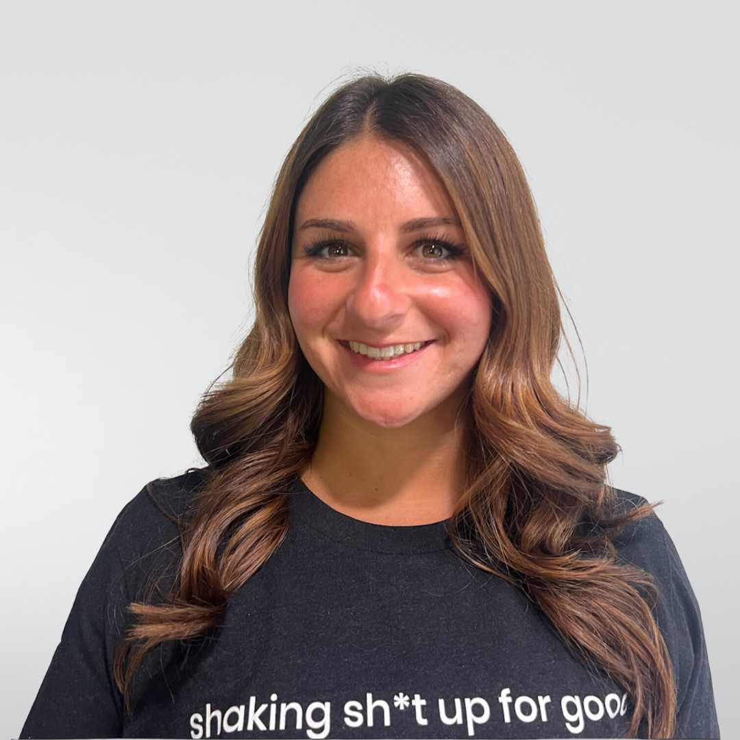 A woman wearing a shirt that says shaking shut up for good