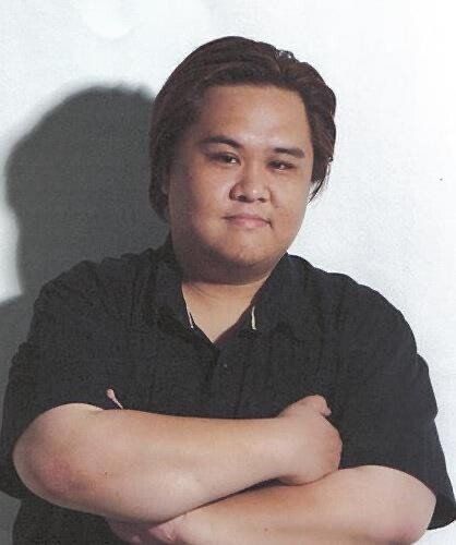 A man with his arms crossed is wearing a black shirt