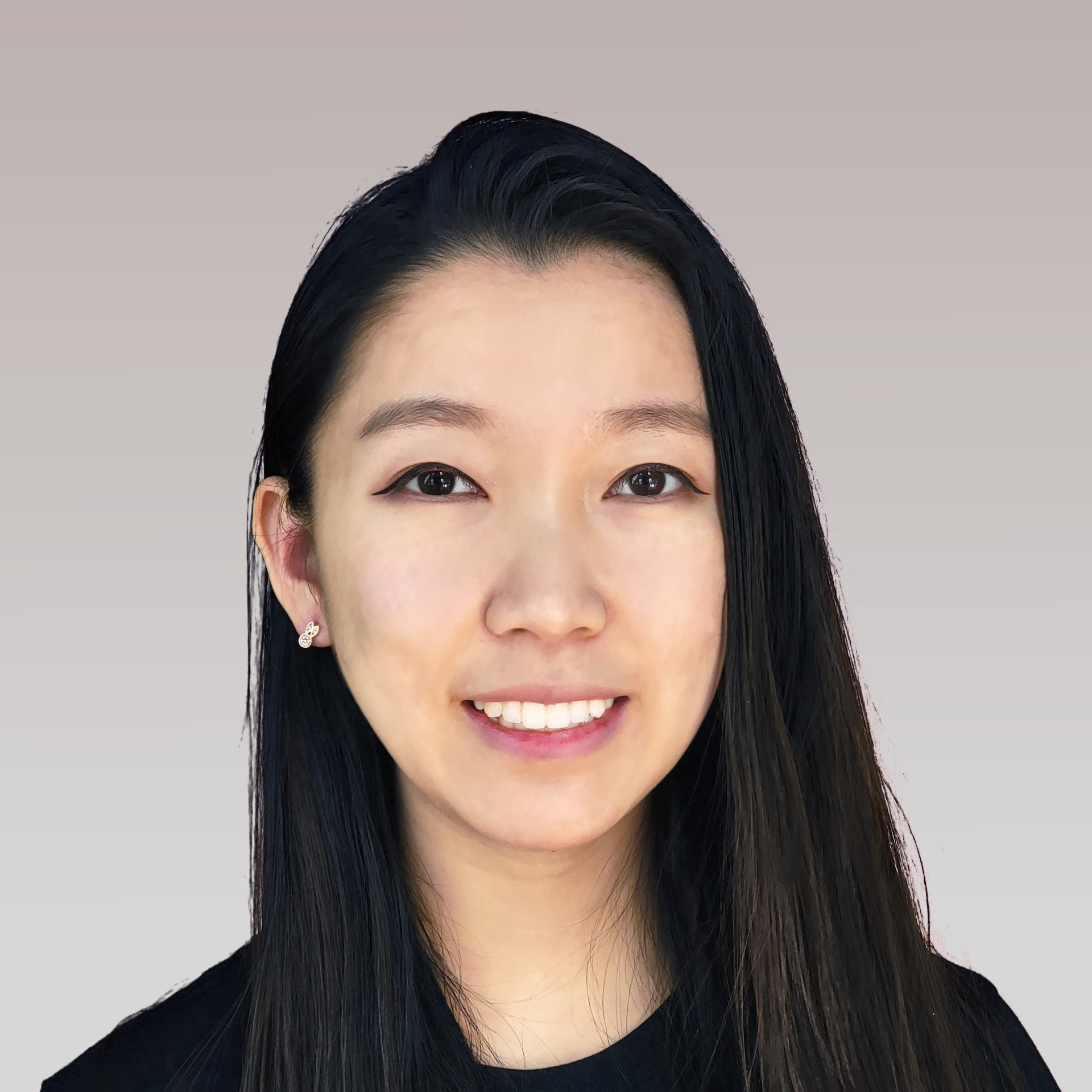 A woman with long hair is smiling and wearing a black shirt