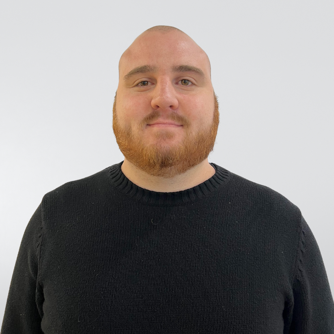 A bald man with a beard wearing a black sweater