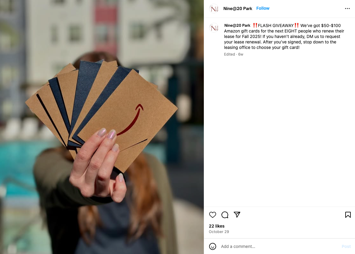 A woman is holding a fan of amazon cards in front of her face.