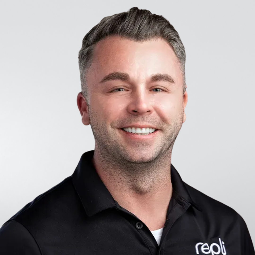 A man wearing a black shirt is smiling for the camera