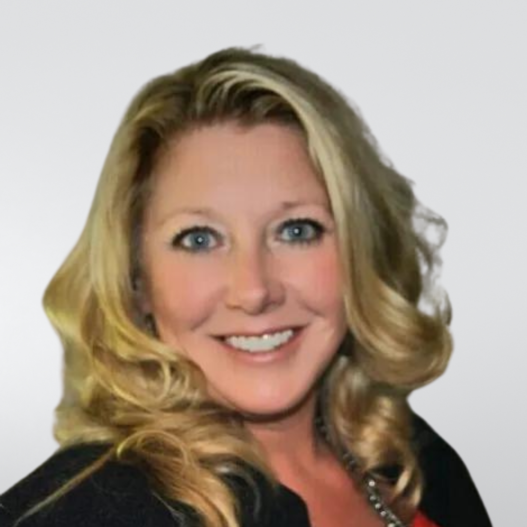 A woman with blonde hair and blue eyes is smiling for the camera