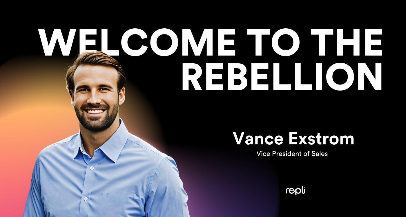 A man in a blue shirt is standing in front of a sign that says welcome to the rebellion.