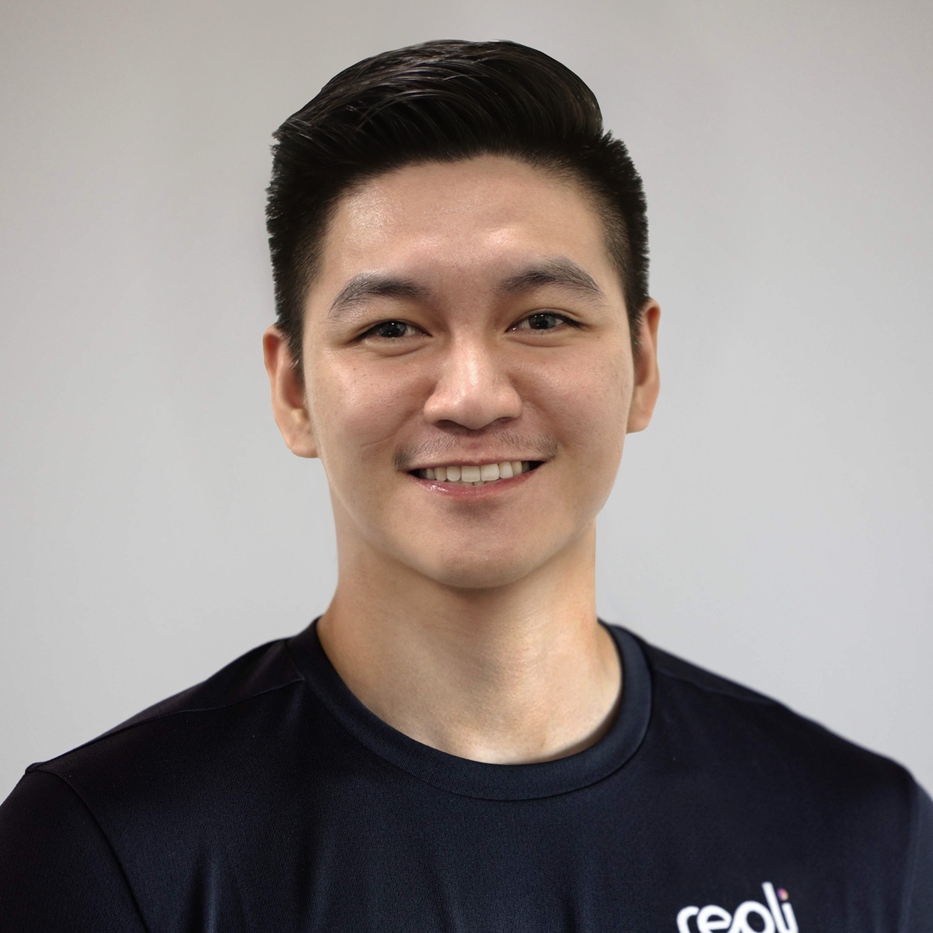 A man wearing a black shirt with the word reali on it