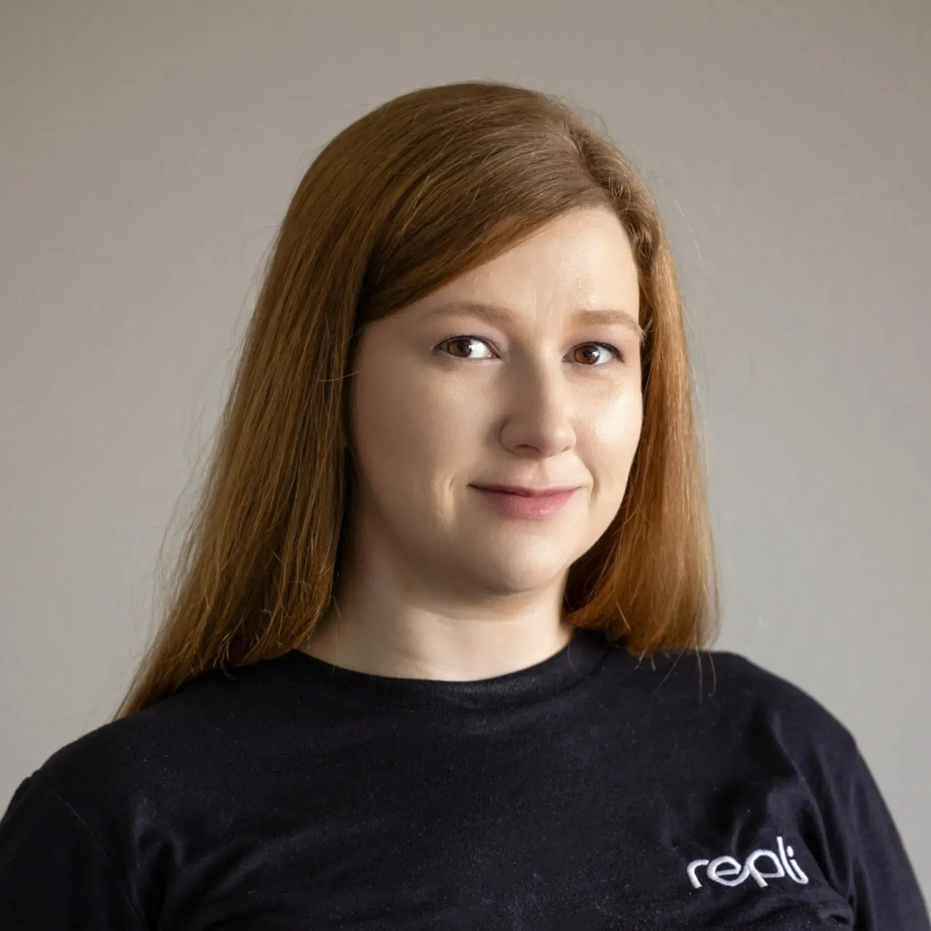 A woman wearing a black t-shirt with the word reali on it.