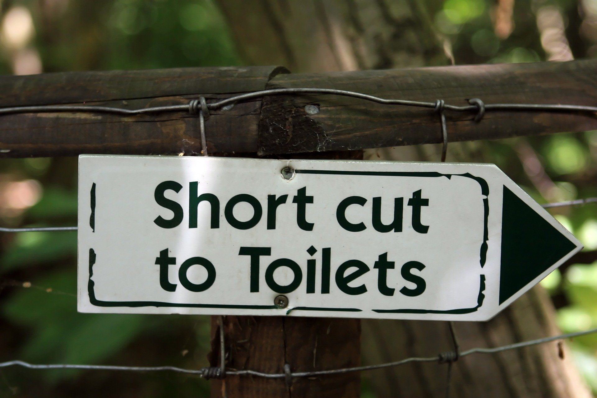sign showing shortcut to toilets