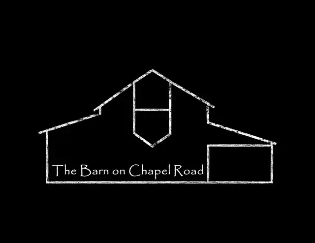 A minimalist white line drawing of a barn on a black background, with the text 