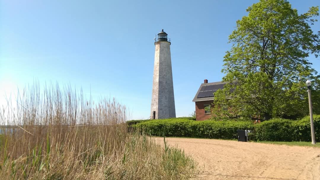 East Shore lighthouse standing tall by calm waters