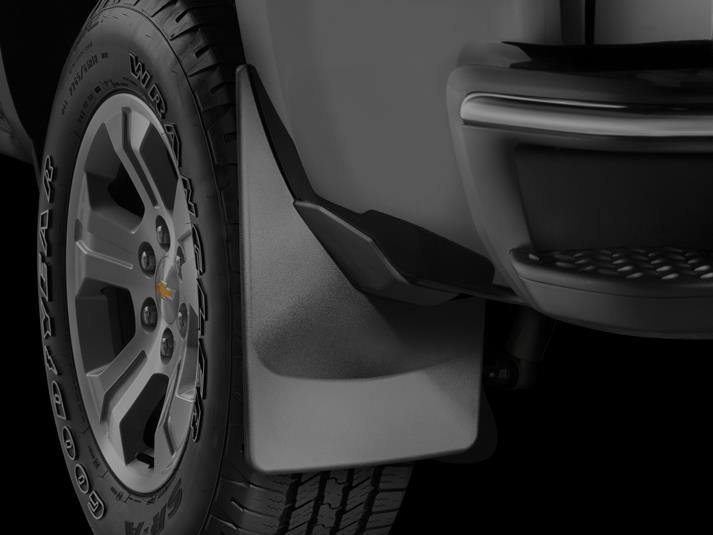 A close up of a car with mud flaps on it.