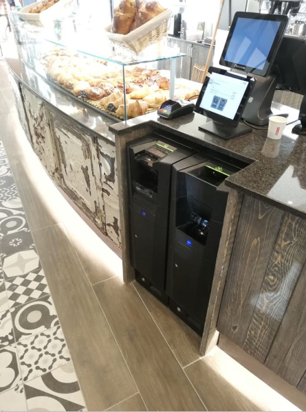 bancone da panetteria con esposizione di dolci e bancomat