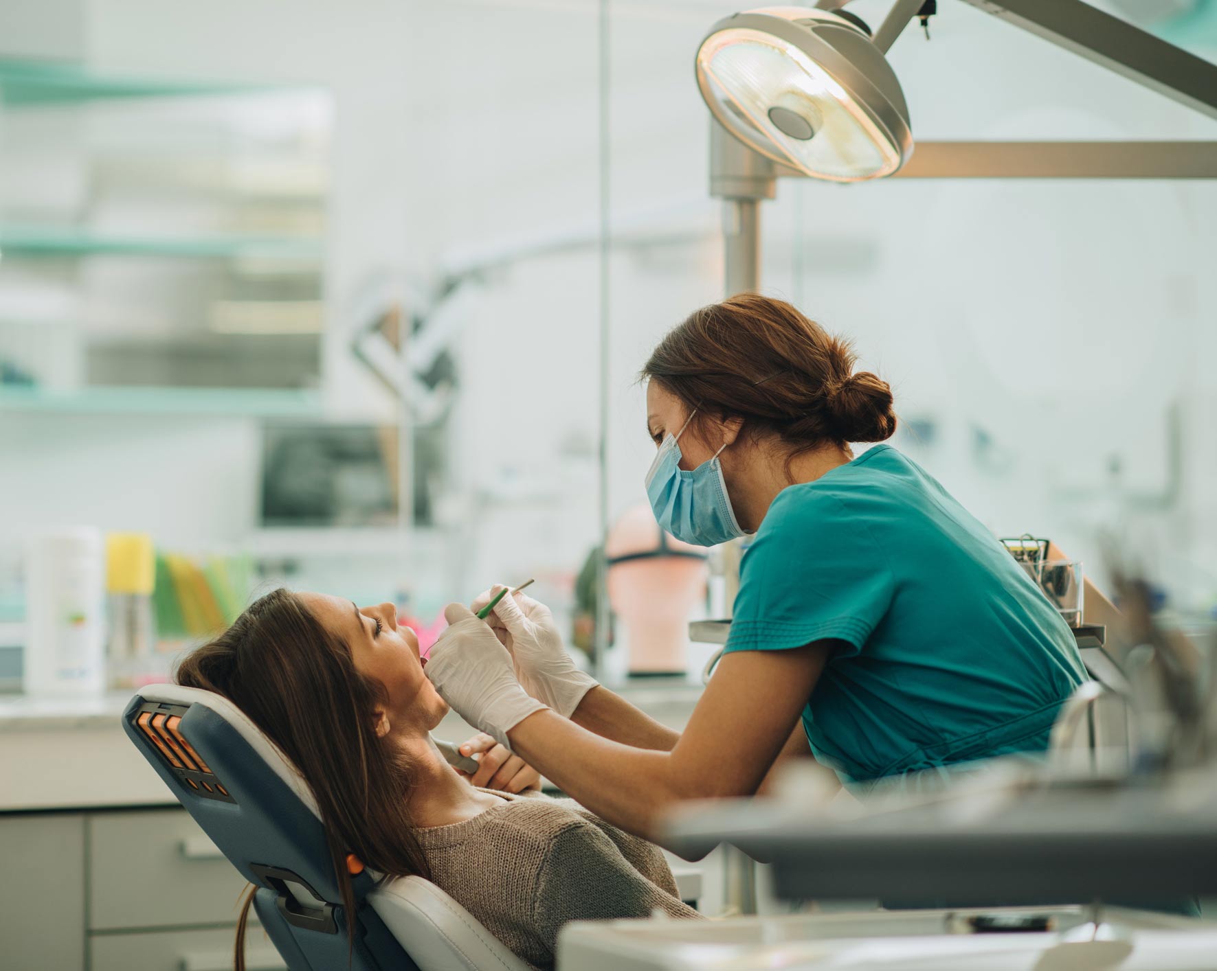 Dentist Examining Young Woman's Teeth — Anchorage, AK — Chinook Family Dentistry