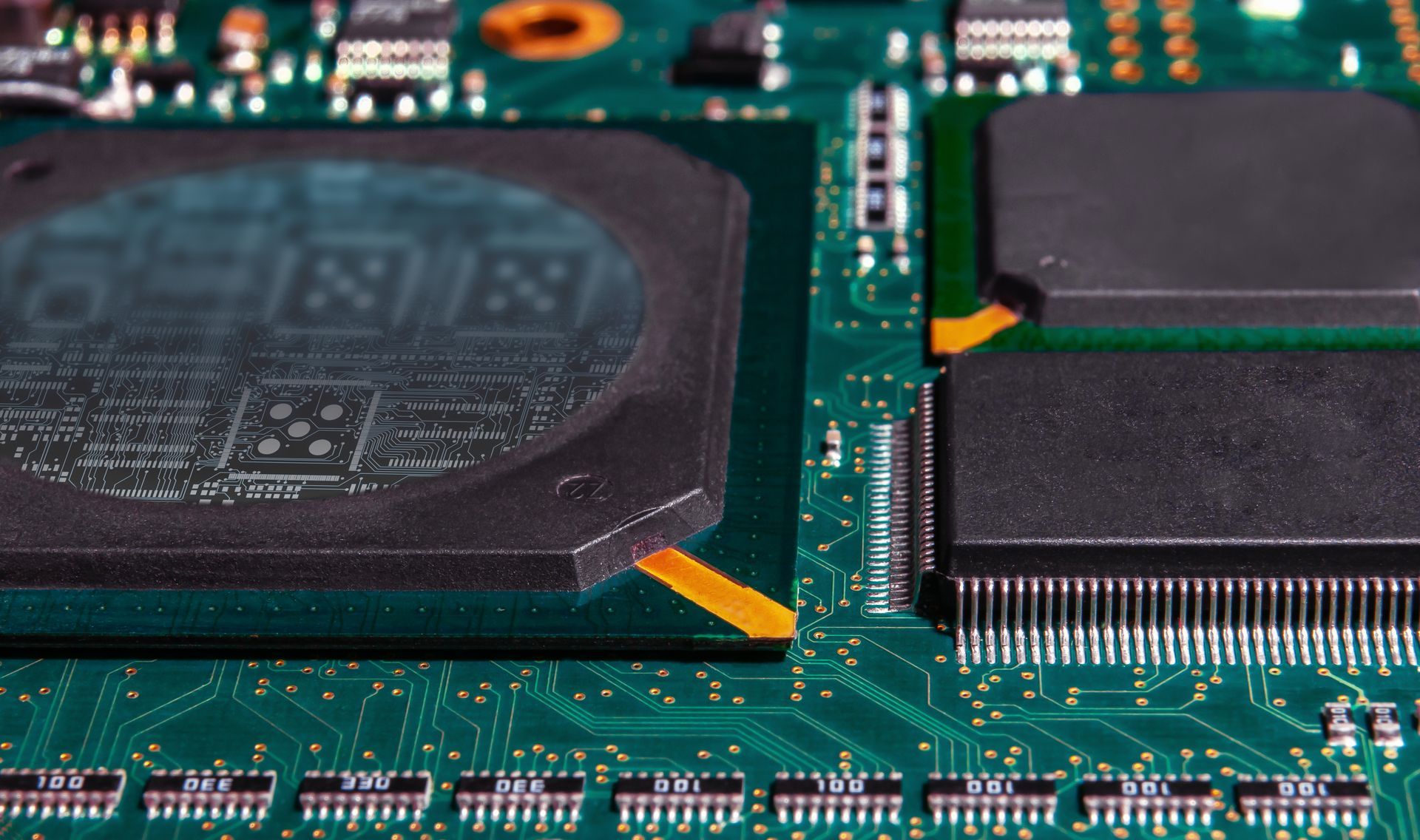 printed circuit board with surface mounted passive and active circuit components close up