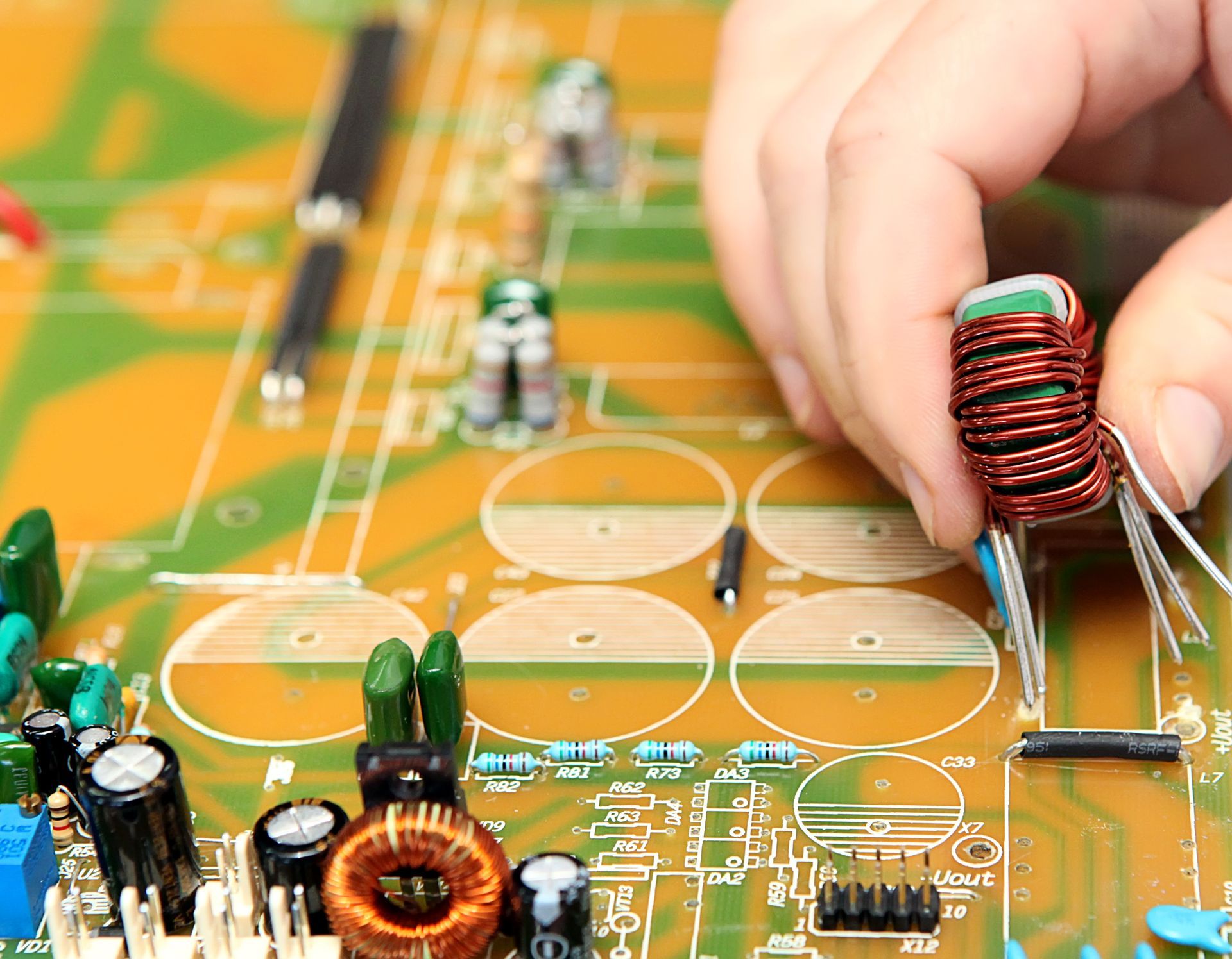 manual insertion of a large through-hole inductor