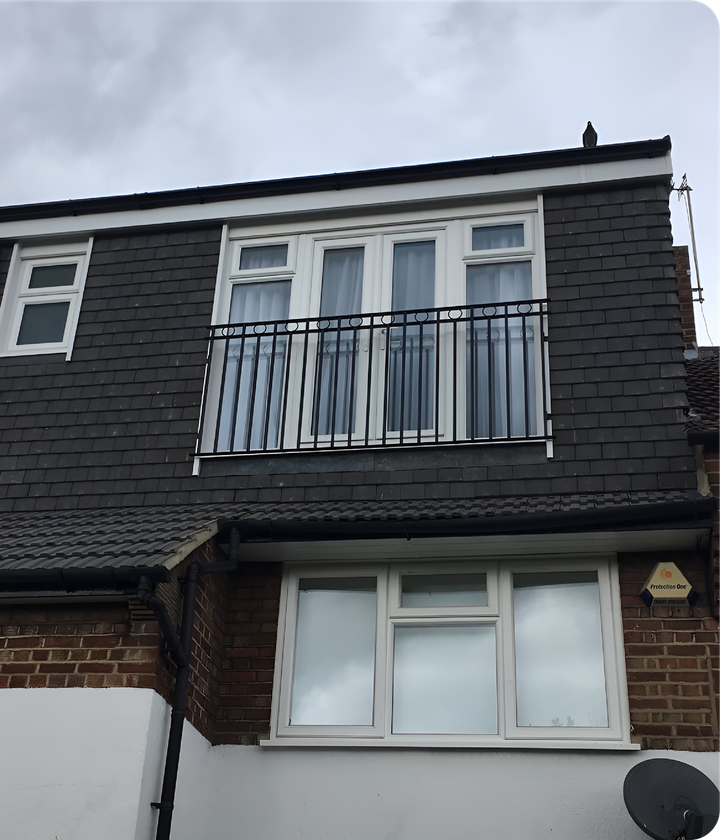A brick house with a balcony on the second floor