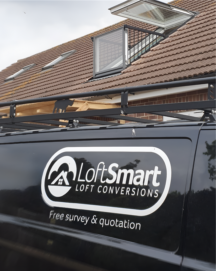 A black van with loft smart loft conversions written on the side is parked in front of a house.