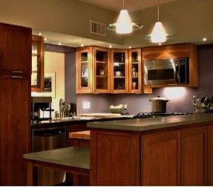 A kitchen with wooden cabinets and stainless steel appliances