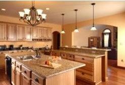 A kitchen with a large island and a chandelier