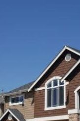 A brown house with a blue sky in the background.