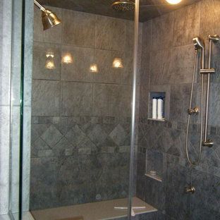 A shower with a glass door and a shower head
