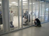 A group of people are working in a clean room.