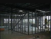 The inside of a building under construction with a lot of metal walls.