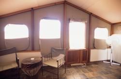 There are two chairs and a table in the room.