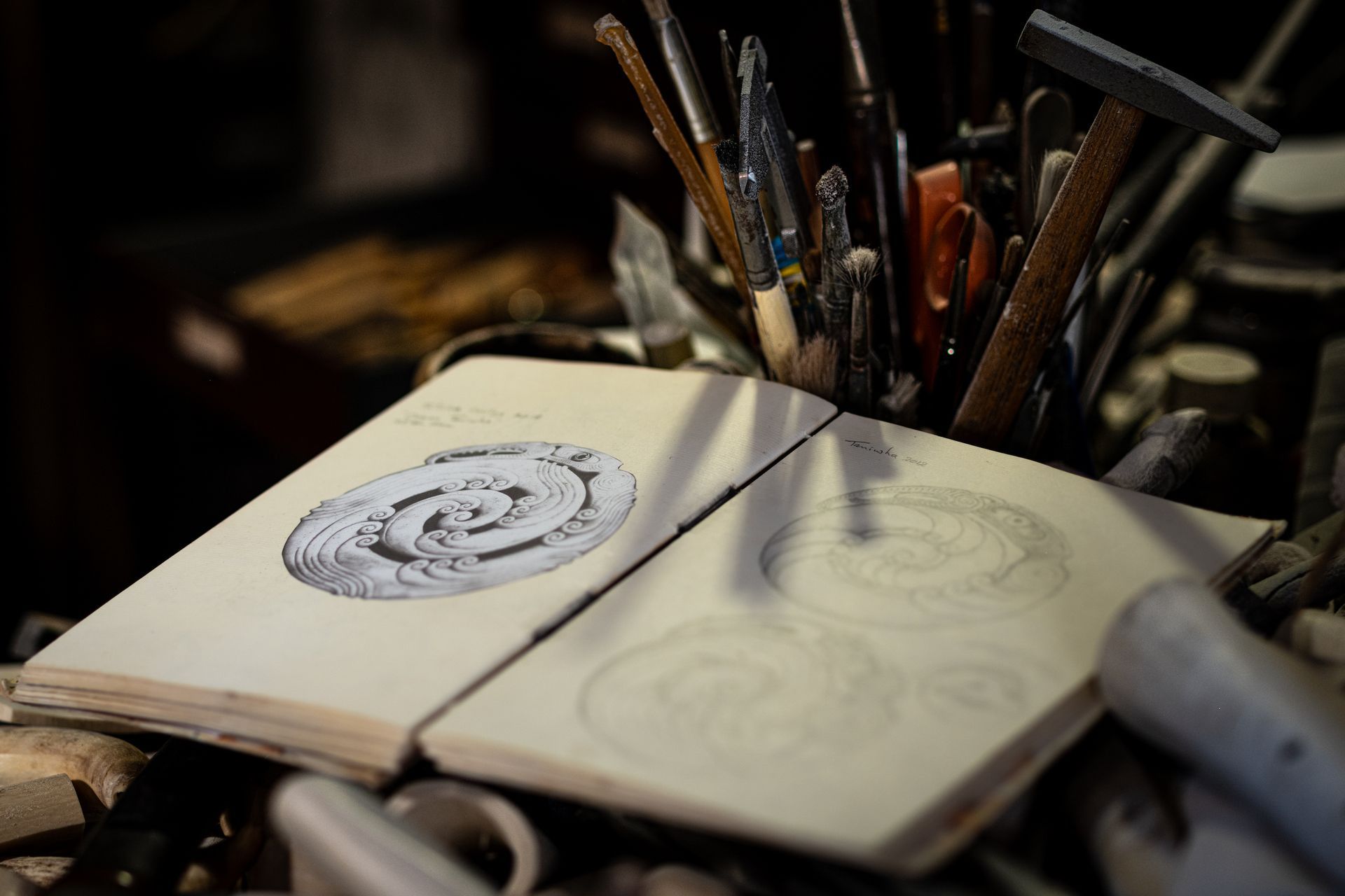 Owen Mapp's design notebook with an image of a circular whalebone carving design.