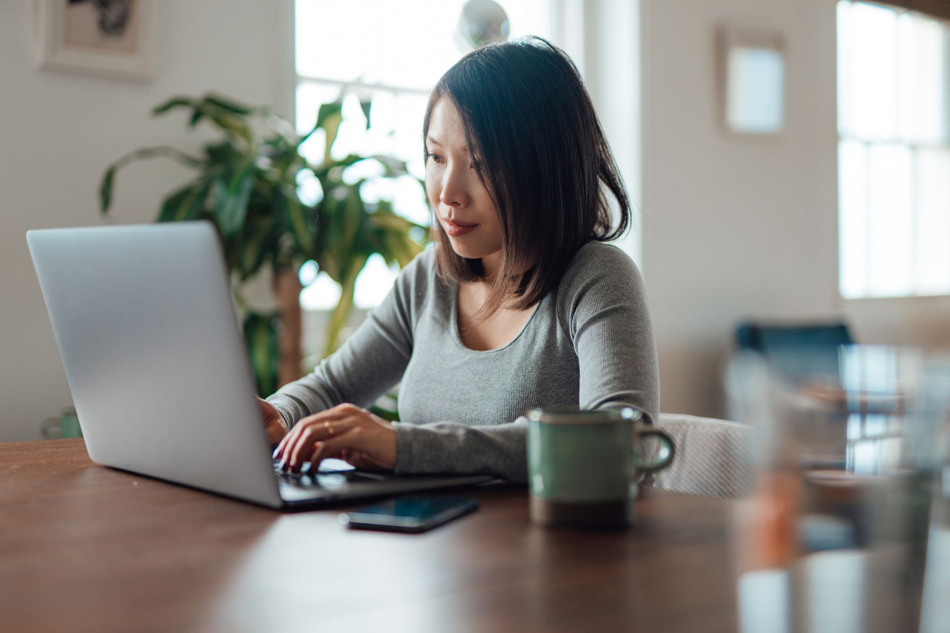 Young Asian woman working from home with laptop