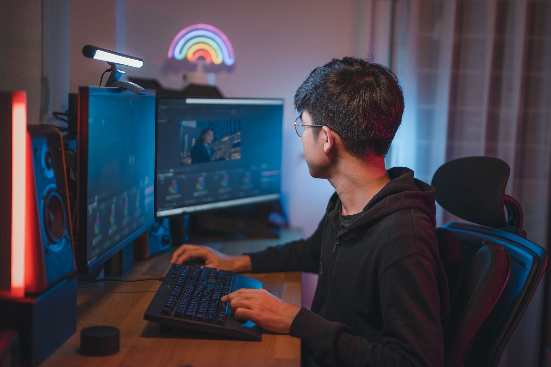 Professional videographer working on a desktop computer.