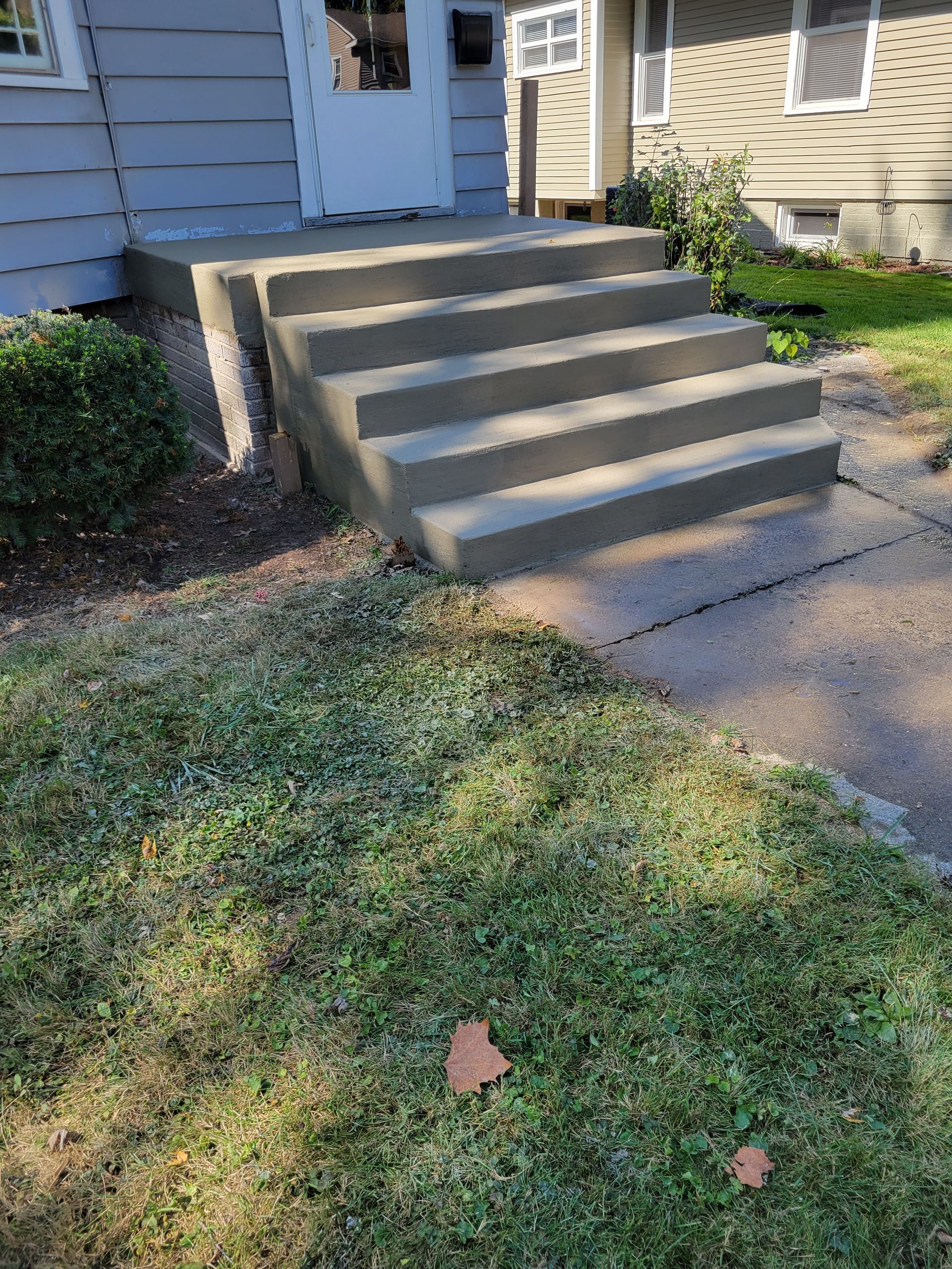 A set of concrete steps leading up to a house.