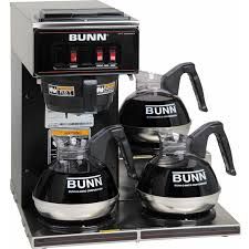Commercial BUNN coffee maker with three glass carafes, stainless steel base and black controls.