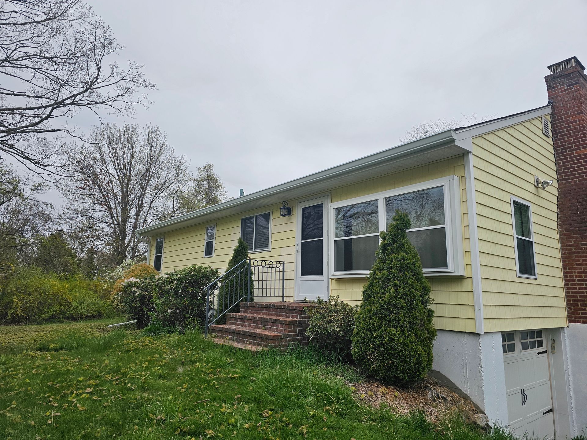 A white gutter with a black roof in the background