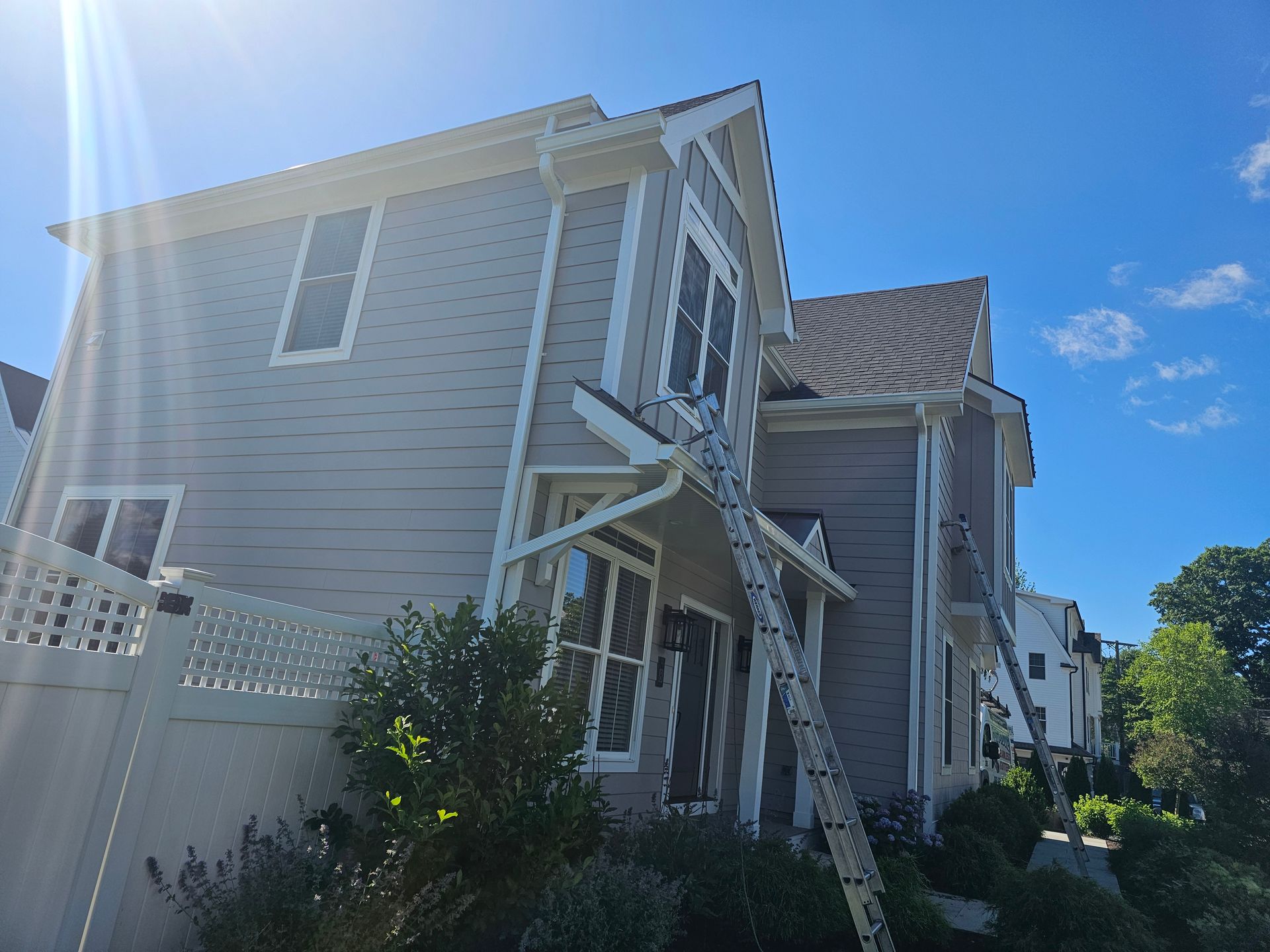 Two men are working on a metal roof.