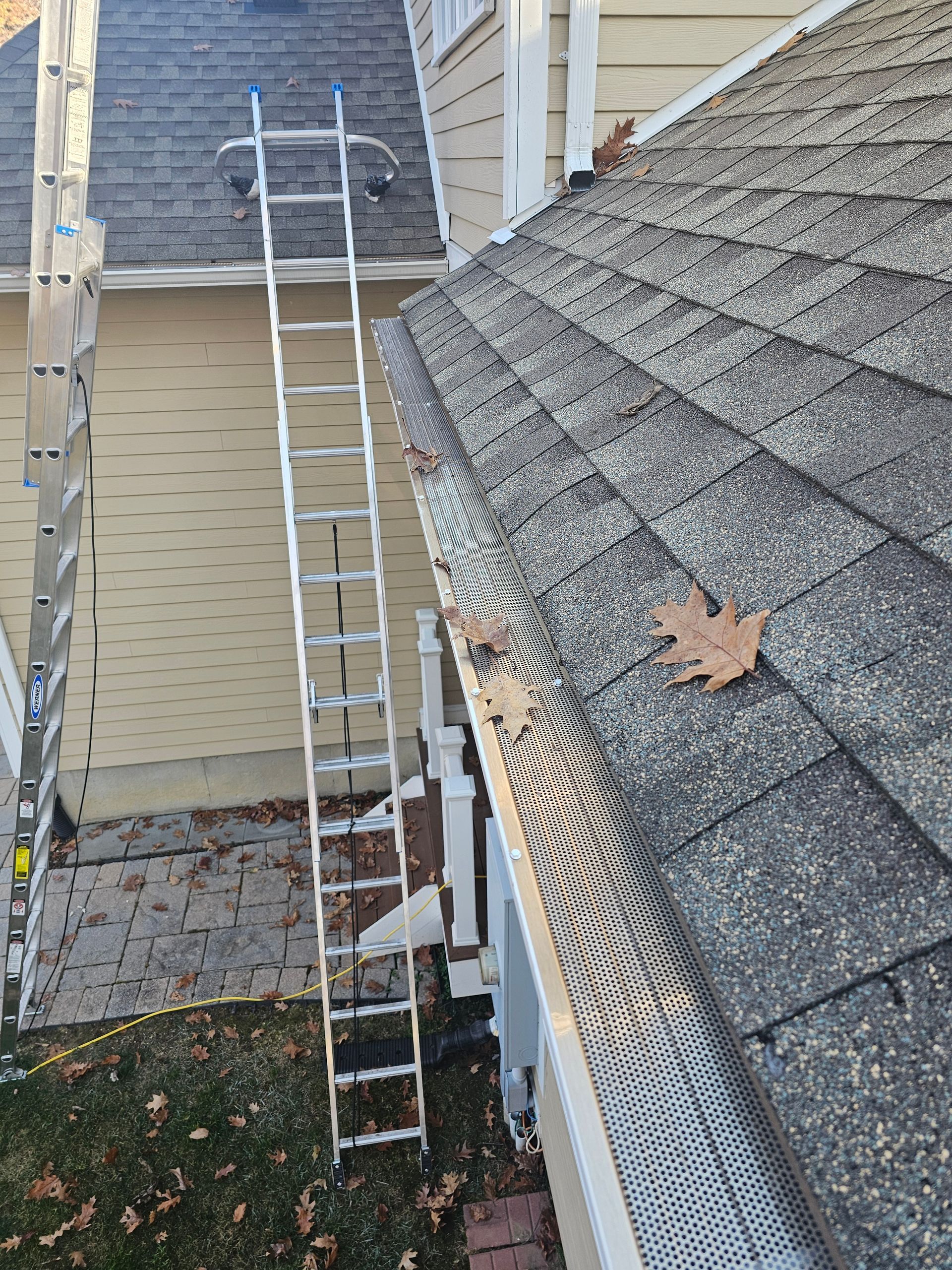 A close up of a gutter with a mesh on it.