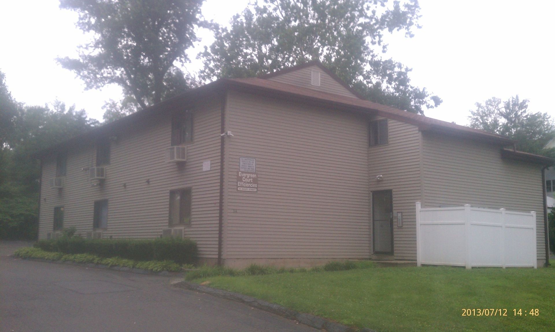A house with a white fence in front of it