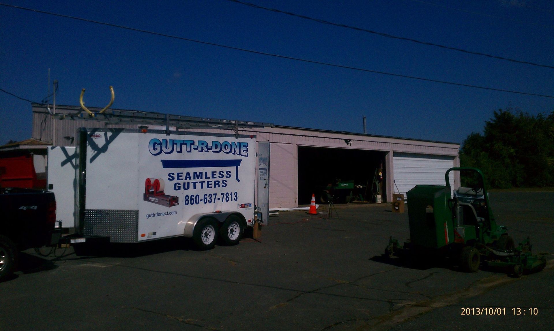 A trailer is parked in front of a building that says outta dome