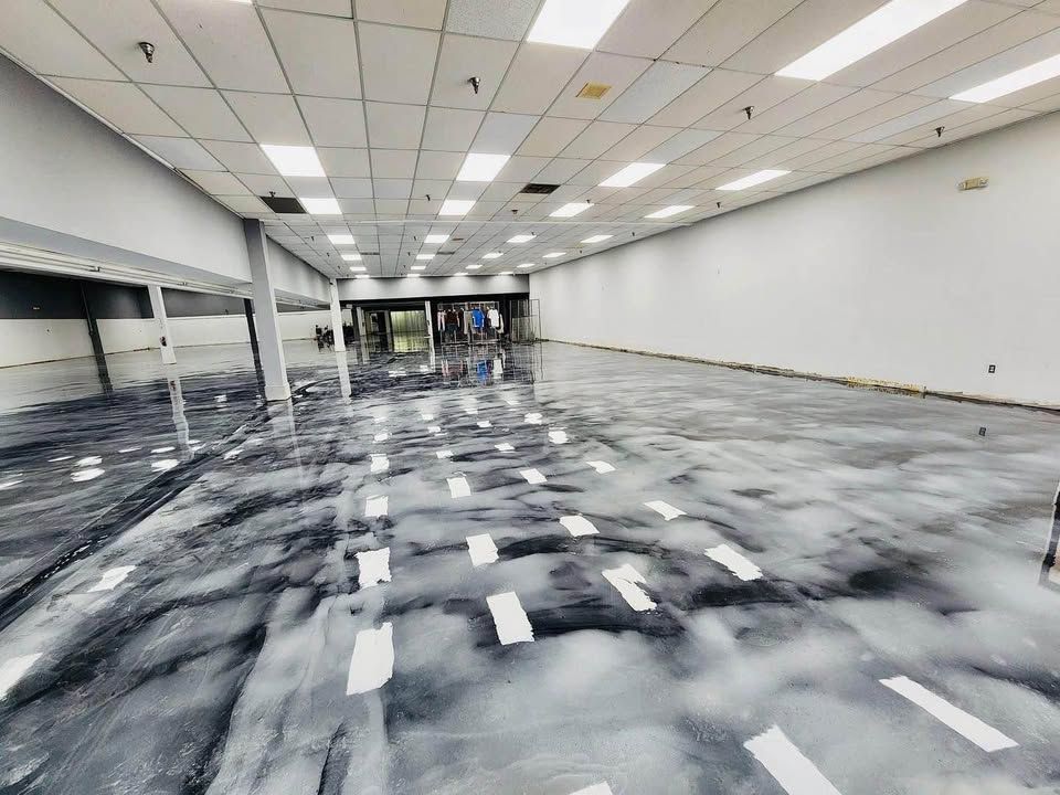 A large room with a marble floor and white walls.